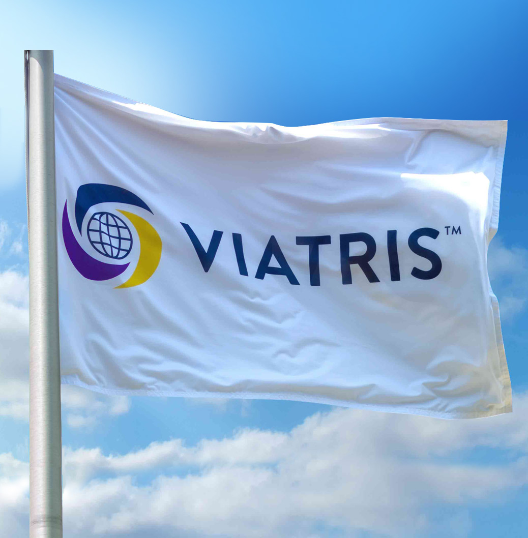 Viatris-lippu heiluu lipputangossa sinistä taivasta vasten.